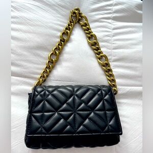 Black leather quilt bag with gold chain handle.  10in drop. Size  9x6x1.5